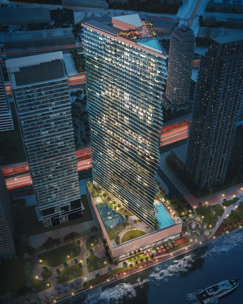 Aerial view of Mar Casa and its podium at night, between the Maritime City towers and the sea